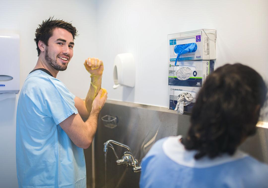 A medical student scrubbing his hands during a rural placement.