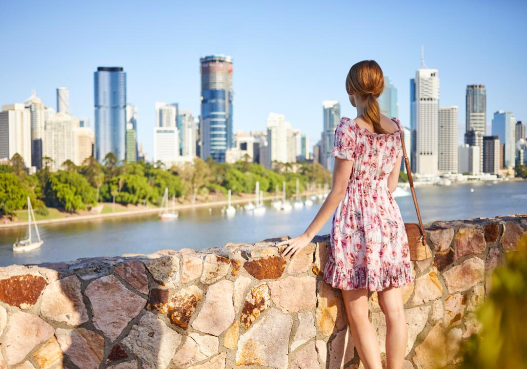 Female student looking at Brisbane's Central Business District from Kangaroo Point.