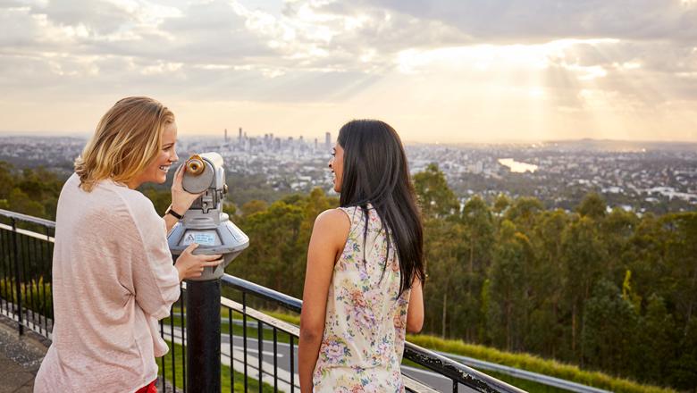 Friends enjoy the view of Brisbane from Mount Coot-tha, Australia
