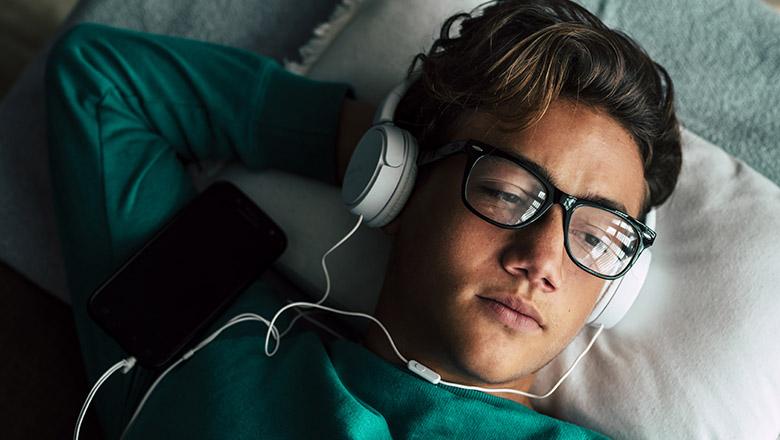 Emotional teenage boy listening to music